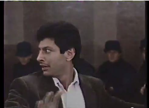 Looking to the right and pointing forward Goldblum (no glasses)